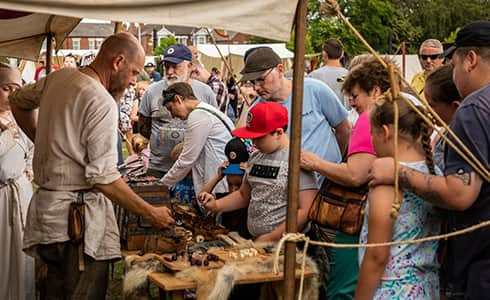 The image shows a busy interactive display with a large interested crowd.